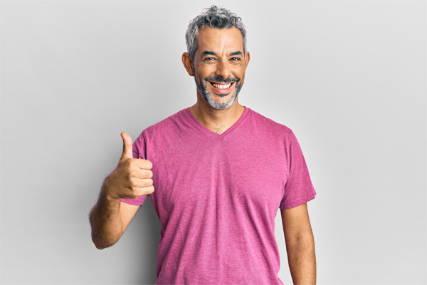 Mature man smiling with thumbs up 